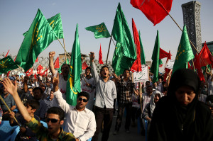 Iranians wave Islamic flags while chanting against the al-Qaida inspired Islamic State in Iraq and the Levant, ISIL, during a rally in central Tehran, Iran, Tuesday, June 24, 2014. (AP Photo/Ebrahim Noroozi)