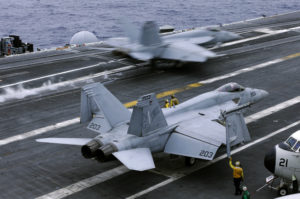 In this file photo from Wednesday, June 15, 2016, an F/A-18 Hornet takes off the deck of the nuclear-powered aircraft carrier the USS John C. Stennis during joint military exercise between the United States, Japan and India off the coast 180 miles east of Japan's southernmost island of Okinawa. The U.S. says at least one Chinese ship tailed the USS John C. Stennis daily during its recent cruise through the South China Sea, although no hostile incidents were reported. (AP Photo/Shizuo Kambayashi, File)