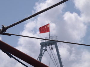 Flag atop a Chinese Coast Guard vessel near Panatag/Scarborough Shoal in the South China Sea. As seen from a Philippine fishing boat on Philippine Independence Day. June 12, 2016. (Photo credit: Anders Corr and Kalayaan Atin Ito.)